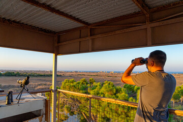 man observing in the telescope from Famagusta view point. Bathing area from the 70's currently...