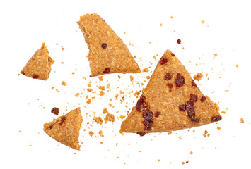 Broken integral tea pastry, cookies with cranberry and crumbs flying isolated on white, top view, clipping 