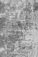 Vertical photo of an old, gray, concrete wall damaged by time.