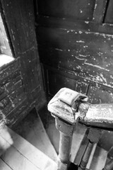 Detailed photo of old wooden bannisters and stairs in stairwell at shabby dilapidated traditional...