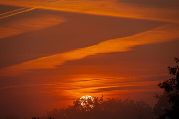 Obraz premium Alencon, France - 08 21 2021: View of a colorful sunrise in the Normandy countryside.