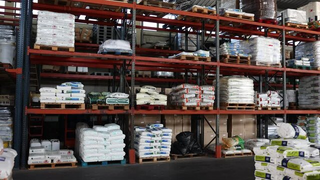 Assortment of organic and mineral fertilizers in bags for sale in agricultural store