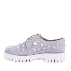 Modern  gray suede women's shoes with white ribbed soles decorated with pearls isolated on a white background with copy space. Discount, season sales. Retail, store, boutique.