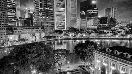 Singapore - August 19, 2023: Aerial view of Boat Quay and city skyline from Cavenagh Bridge