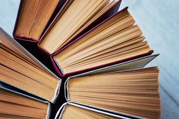 Book volumes in a vintage style, an atmosphere of reading, learning languages, gaining new knowledge. School, university, college or library. Reading fiction, background, texture, selective focus
