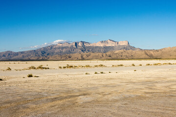 View of the Guadalupe Mountains and El Capitan from highway 62 in west Texas with the Salt Flats in...