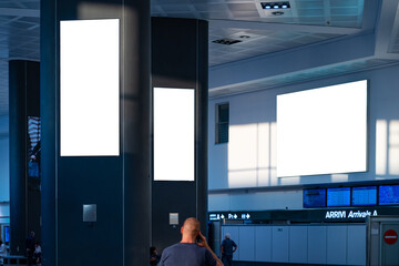 Fototapeta premium Billboards inside an airport building in Italy.