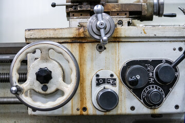 Old lathe machine on the background close-up image