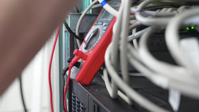 The repairman connects electronics in medical equipment. 