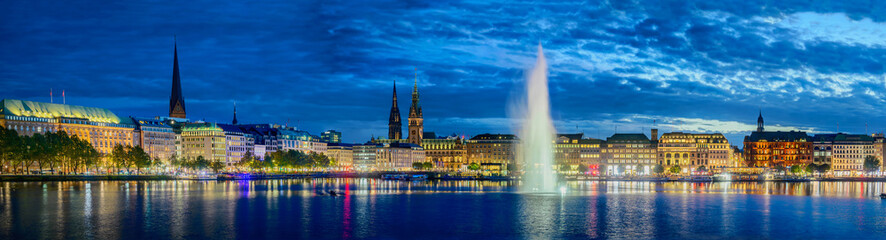 Panorama view of Hamburg's Alster Lake, where the Alster fountain takes center stage, surrounded by...