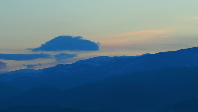 Clouds Over The Mountains And Morning Light Shining Through. Abstract Nature Background. Timelapse.