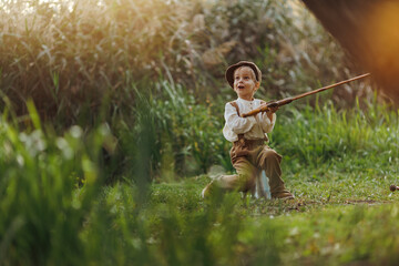 Child fishing at autumn lake