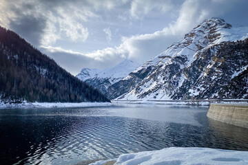 Scenic view of Lago di Livigno with Punt dal Gall arch dam in winter