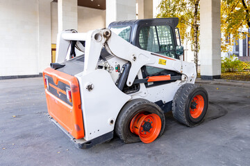 Compact loader with broken wheel. Broken tire on a municipal vehicle. Equipment malfunction, loss of income. Broken transport awaiting repair © hodim