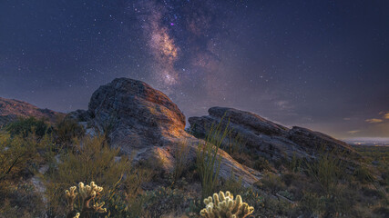 The Milky Way galaxy rising over a lone rocky desert - obrazy, fototapety, plakaty