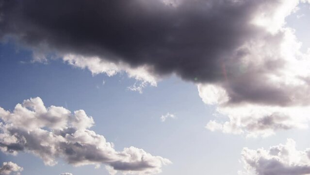 The Sun Casting Its Light Amidst The Clouds