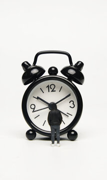 Selective focus picture of alarm clock with miniature insight. Time abstract concept.