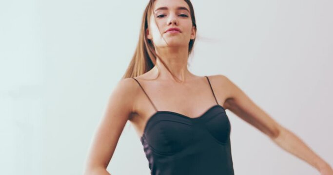 Face, dance and woman with ballet, spin and performance with talent on a studio white background. Portrait, person and model with practice, energy and smile with creativity, artistic and ballerina