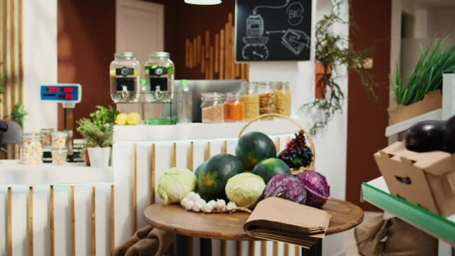Chemicals free pantry staples and vegetables in eco friendly zero waste supermarket. Organic food in decomposable reusable glass jars in empty local neighborhood grocery store, zoom out shot