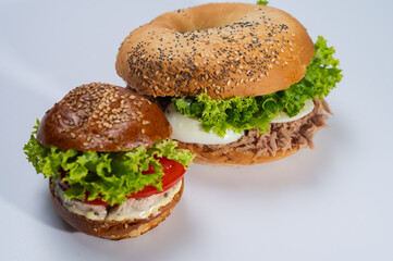 close-up on light surface, various hamburgers, meat, fish and tuna hamburgers for restaurant menu on white background. Isolated, close-up view