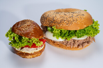 close-up on light surface, various hamburgers, meat, fish and tuna hamburgers for restaurant menu on white background. Isolated, close-up view