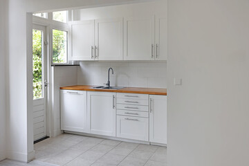 Fototapeta na wymiar Interior of modern kitchen with stylish white furniture