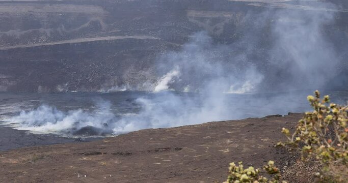 Hilo Hawaii Kilauea volcano steam smoke crater. Most active volcano in the USA. Smoke, steam, gasses. Big Island in Volcano National Park. Eruptions and lava flow continually. Geological crater.