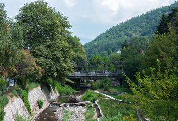 Fototapeta na wymiar Bistritsa - mountain river with a beautiful bridge in Blagoevgrad town, Bulgaria