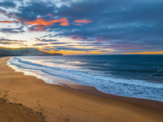 Fototapeta na wymiar Surf, sea, sand, sunrise with clouds