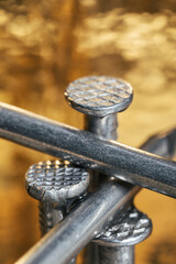 Carpentry metal nails on a golden background. Bright and shiny concept.