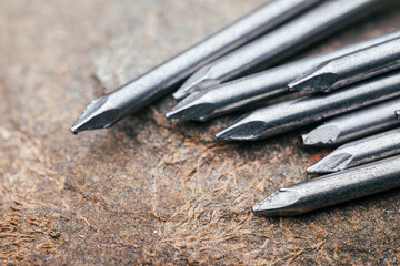 A pile of steel nails on a stone. Background with steel nails.