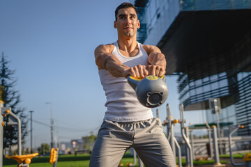 One man young adult caucasian male train with kettlebell girya weight