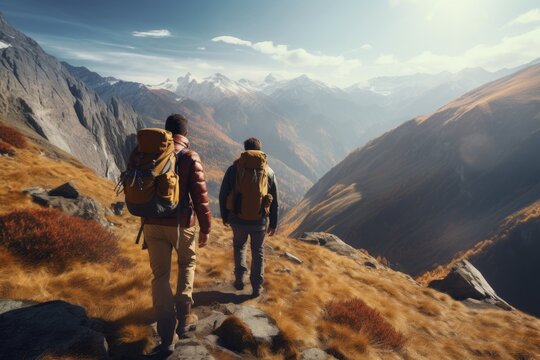 Hikers on Mountain Pathway, Autumnal Grasslands in Foreground, Overlooking Majestic Mountain Ranges in Soft Sunlit Glow