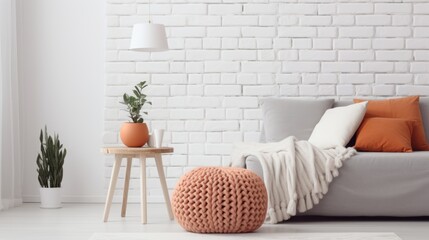 Knitted Pouf, White Sofa, Terra Cotta Pillows, and Blanket Create Cozy Home Interior Design, Scandinavian Hygge-Style Living