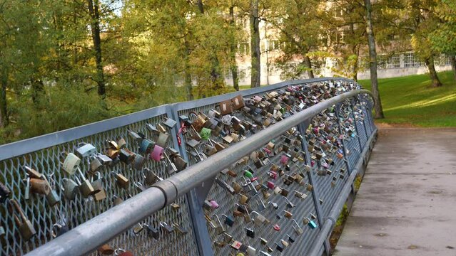 Total of a bridge with love locks hanging on it's fence.
