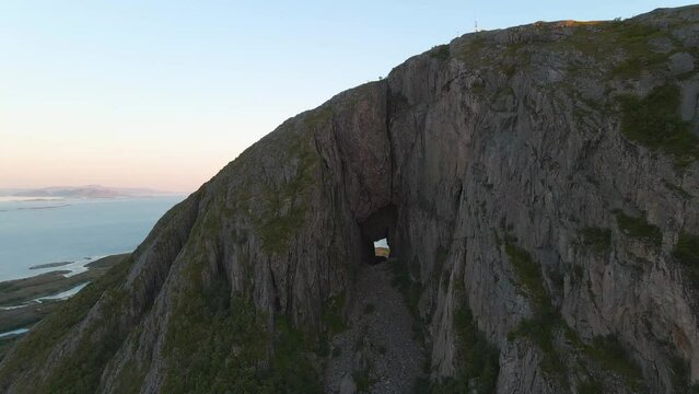 Torghatten is a mountain on Torget island in Nordland county, Norway. It is known for its characteristic hole, or natural tunnel, through its center.