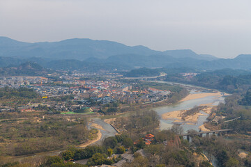 Fototapeta na wymiar The view on the village by the river from Da Wang Shan Peak in Fujian, China