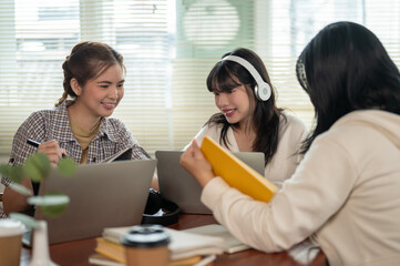 A group of happy young Asian female college friends are helping each other prepare for the exam.