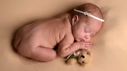 Sleeping newborn cute baby girl or boy during first week of life. 4k slow motion120 fps raw video. Happy family concept. Small baby sleep in bed with small bear toy in hand and nipple