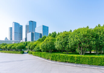 The green belt of Shanghai Bund Park and the skyline of urban architecture in the distance