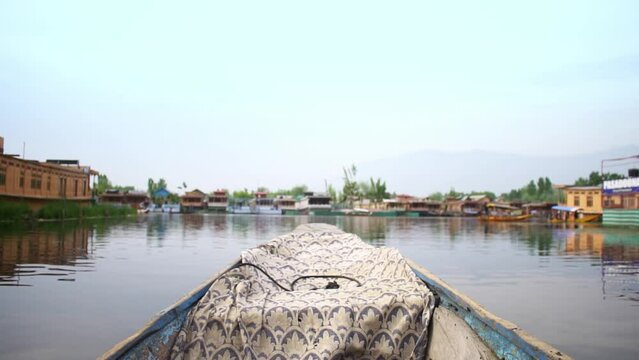 POV from a  Shikara gently gliding through the Dal lake in Srinagar, Kashmir
