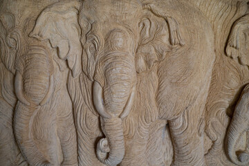 A stone carved elephant to be used as a wall decoration for your home or garden.
