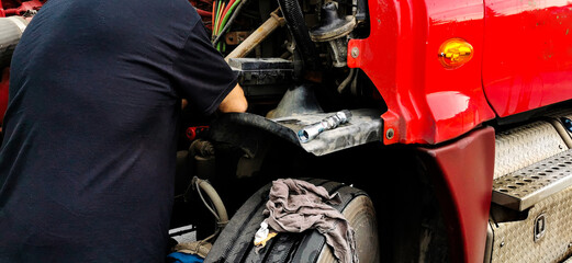 a professional mechanic repairing a heavy truck engine