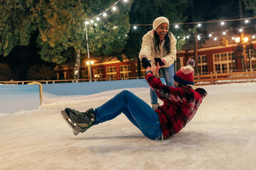 Girlfriend is helping her boyfriend on ice rink