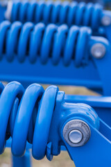 Steel blue spring as part of agricultural machine. Technology