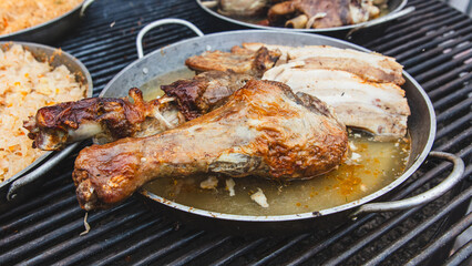 The meat is fried in a frying pan on the grill