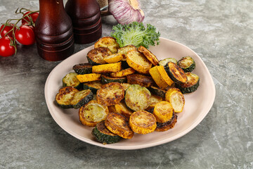 Roasted young zucchini in the plate