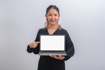 Portrait of young happy business woman holding white screen laptop. Attractive female in smart casual wear holding a computer and present her job or work. Digital tachnology communication concept.