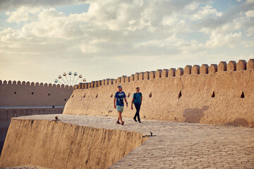 Tourist at City walls of the ancient city of Khiva Uzbekistan