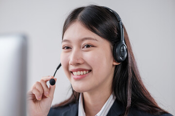 Happy smiling female customer service operator working on computer in office